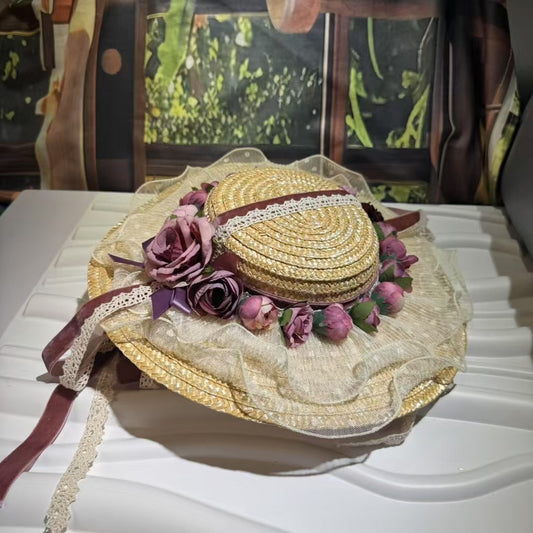 Discover the Amelia, a vintage-inspired straw hat with dusty mauve roses, a lace brim, and velvet ribbons. Perfect for Victorian events, photoshoots, and romantic occasions.