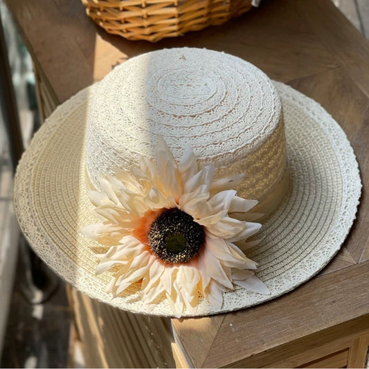 Discover our elegant cream sun hat, crafted from a breathable cotton and papyrus blend. Features a beautiful apricot sunflower and lace-like weave. Perfect for bridal events.