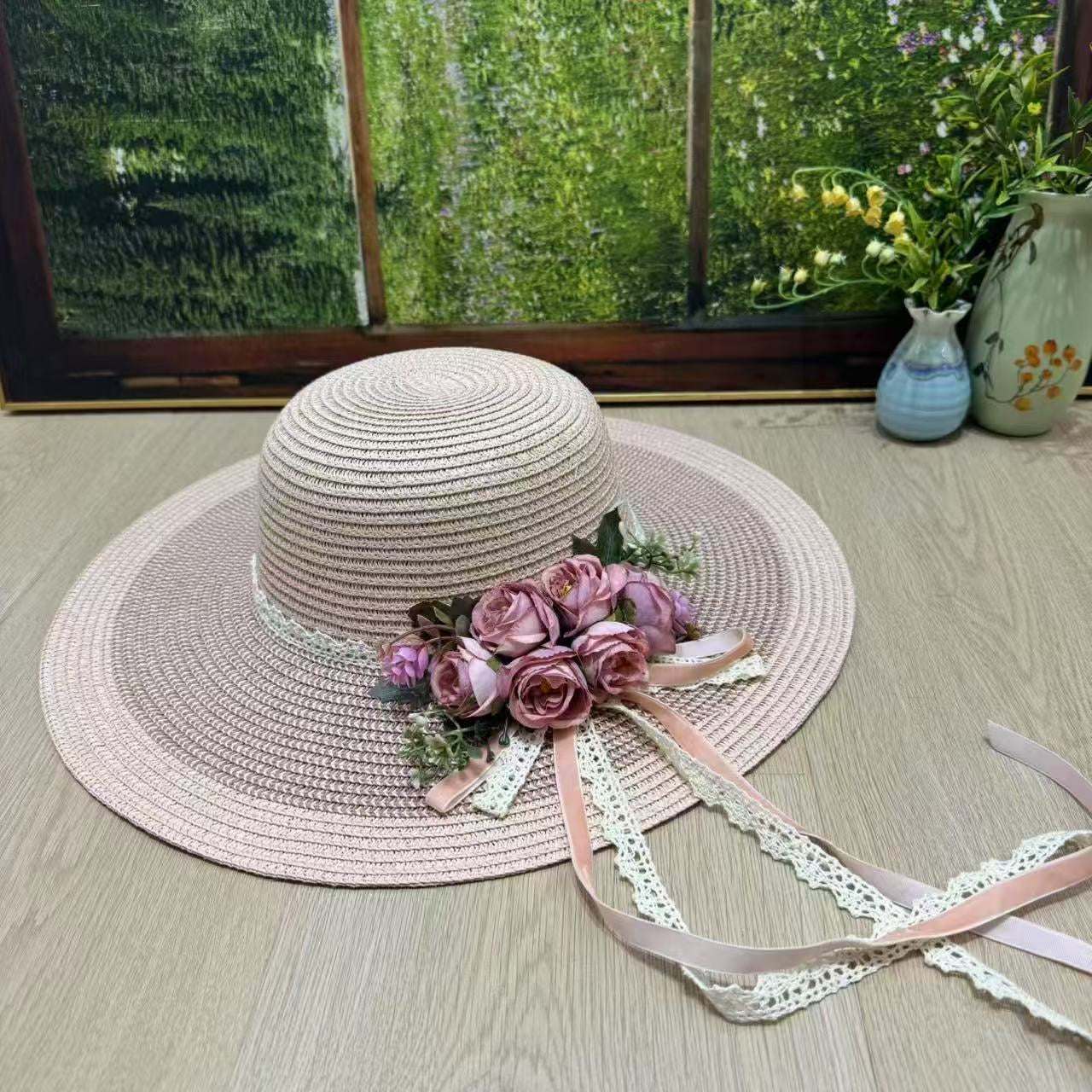 Dusty rose wide-brim hat with pink roses and flowing lace ribbons