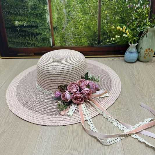 Dusty rose wide-brim hat with pink roses and flowing lace ribbons