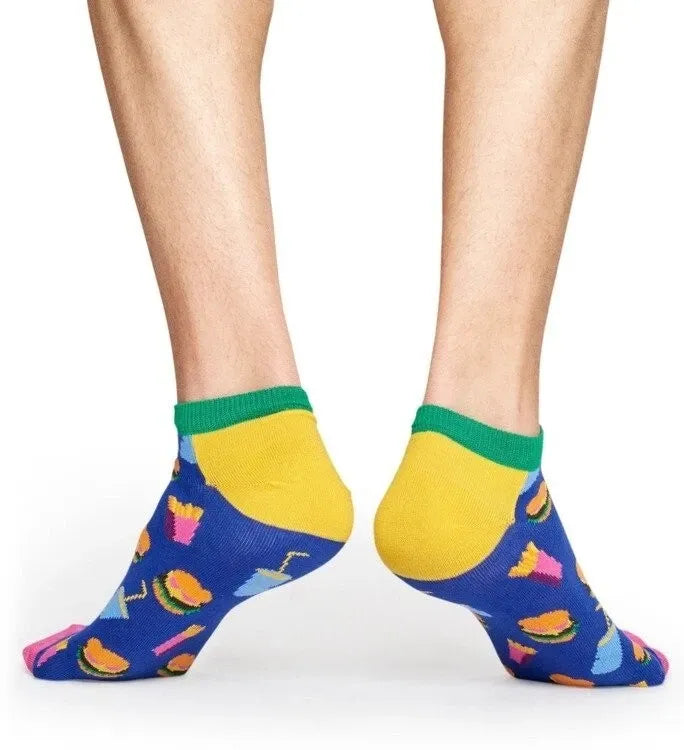 Colorful socks with a burger pattern worn by a person on a white background