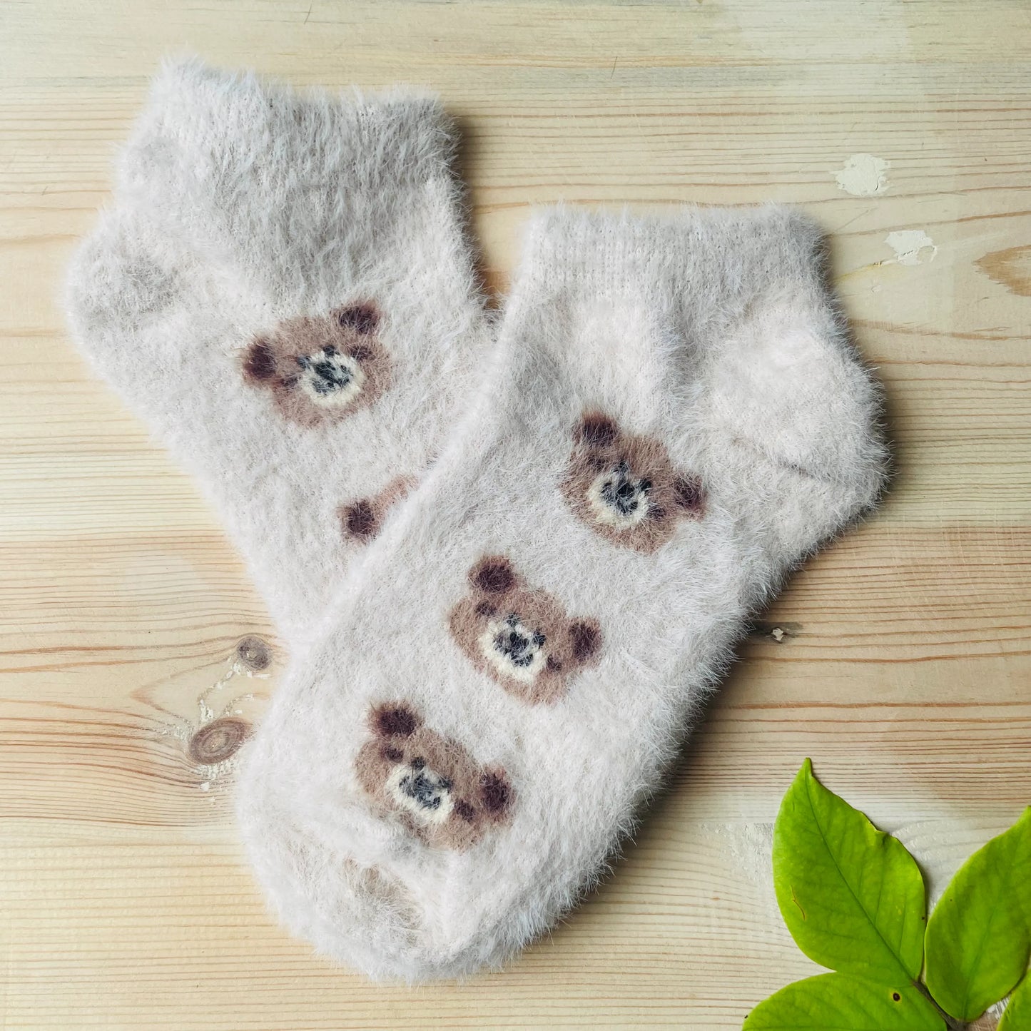 A pair of light grey soft mink-style unisex socks with a cute bear pattern for daily wear.