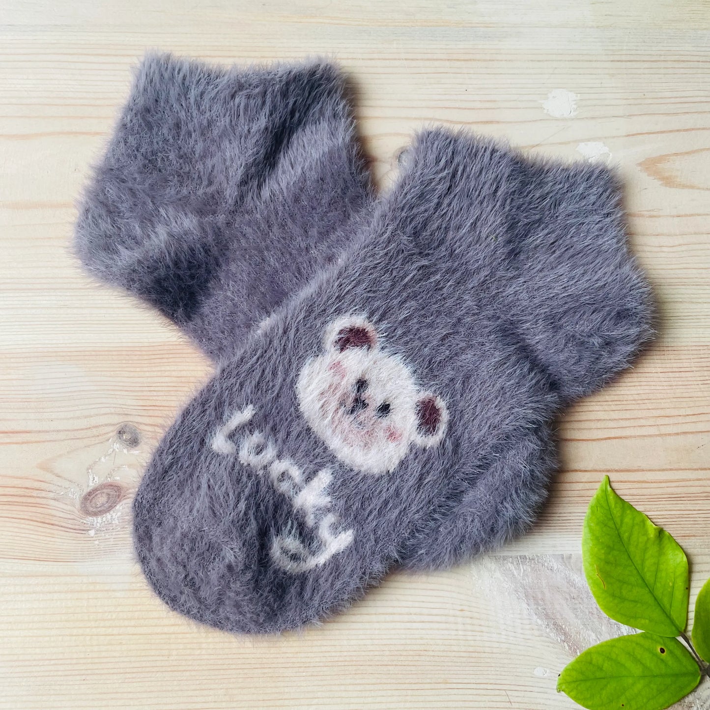 A pair of "Lucky" bear themed dark grey unisex winter socks.
