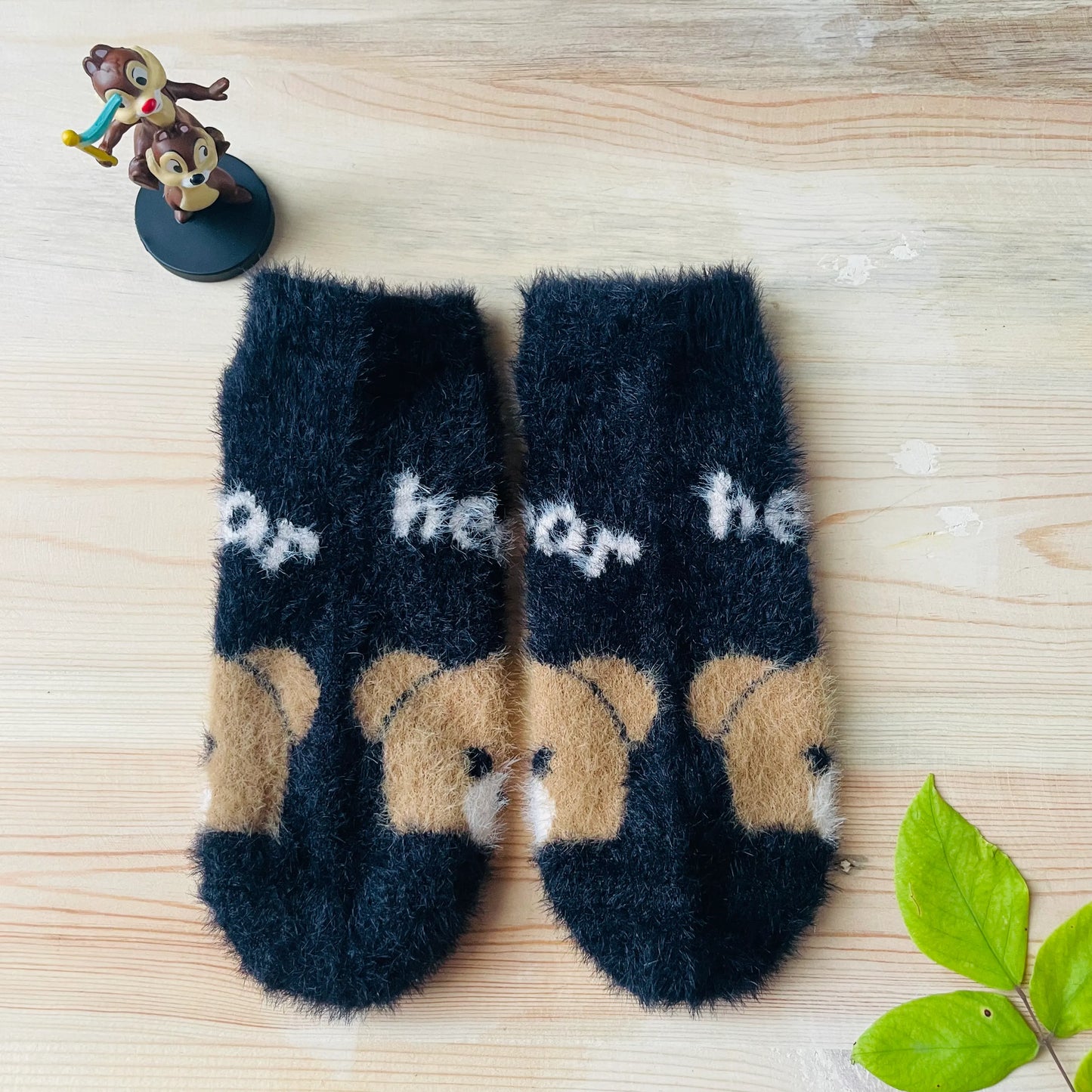 Top view of the black fuzzy bear socks, ideal for lounging at home.