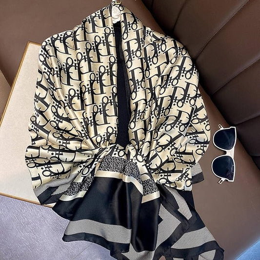 Elevate your style with this luxurious silk-feel satin scarf. Featuring a bold black and white monogram print with elegant contrasting borders, this 90 x 180 cm scarf is the epitome of chic sophistication.
