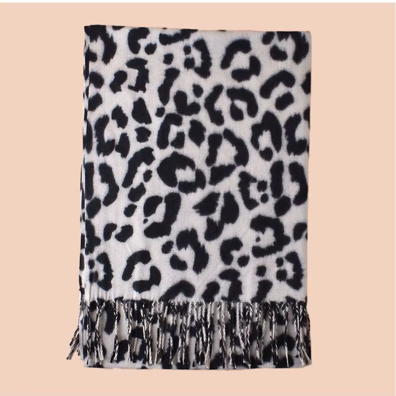 Leopard print scarf with fringe on a beige background