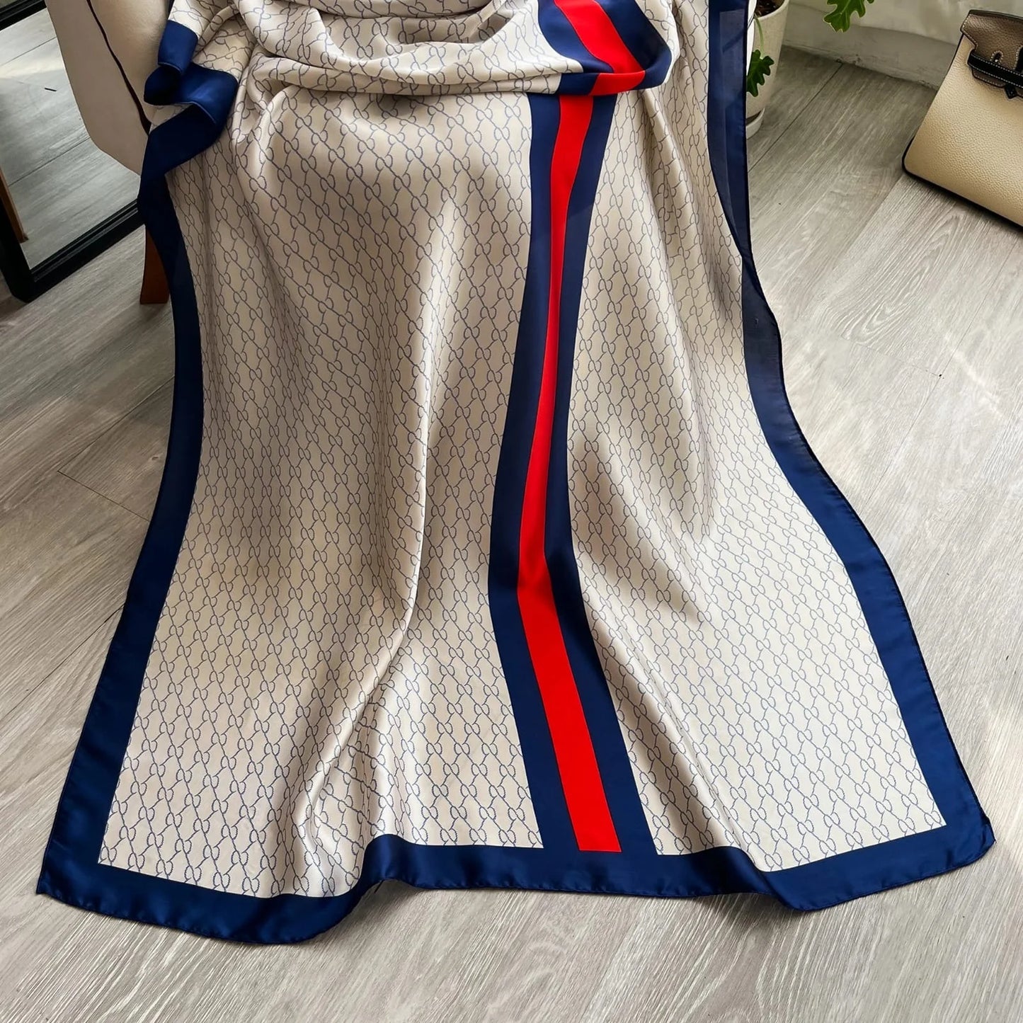 Elevate your style with this luxurious silk-feel satin scarf in white monogram with bold red and blue stripes. Measuring 90 x 180 cm, it’s perfect for evening wear, travel, or as a sophisticated gift.