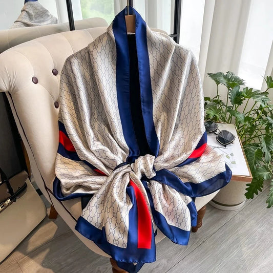 Elevate your style with this luxurious silk-feel satin scarf in white monogram with bold red and blue stripes. Measuring 90 x 180 cm, it’s perfect for evening wear, travel, or as a sophisticated gift.