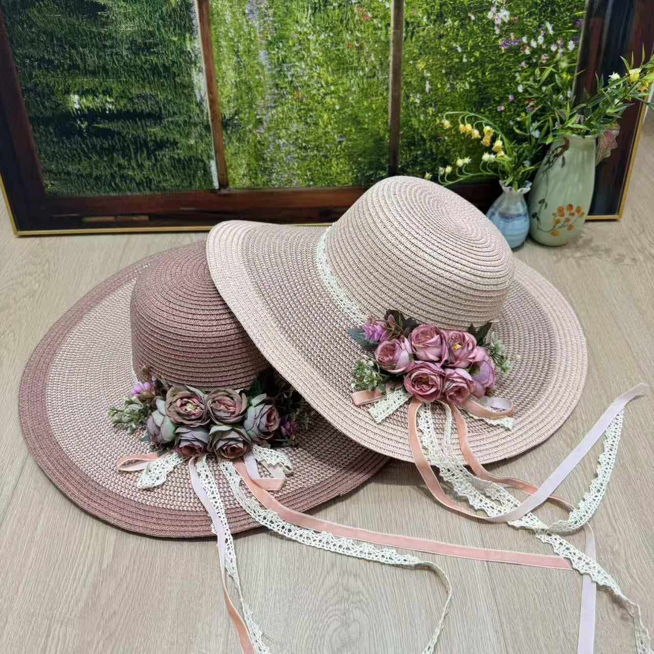 pink wide-brim sun hat with pink roses, greenery, and lace satin ribbons