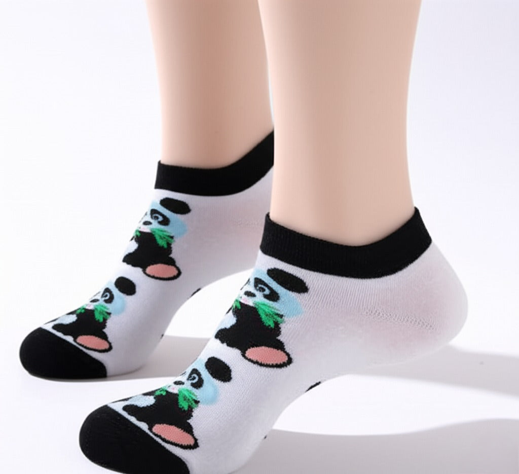 White socks with panda design worn by a person on a white background