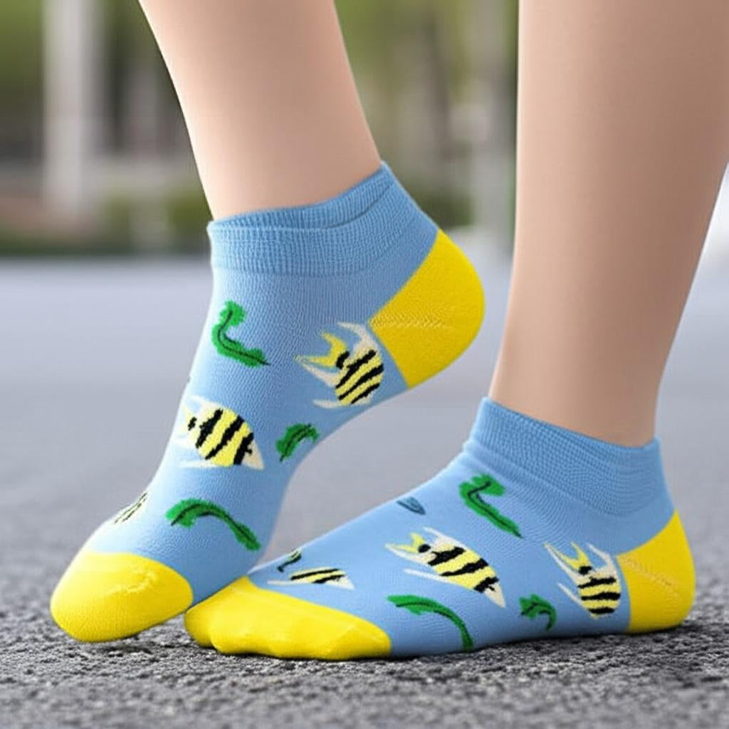 Blue socks with fish patterns worn on a blurred outdoor background