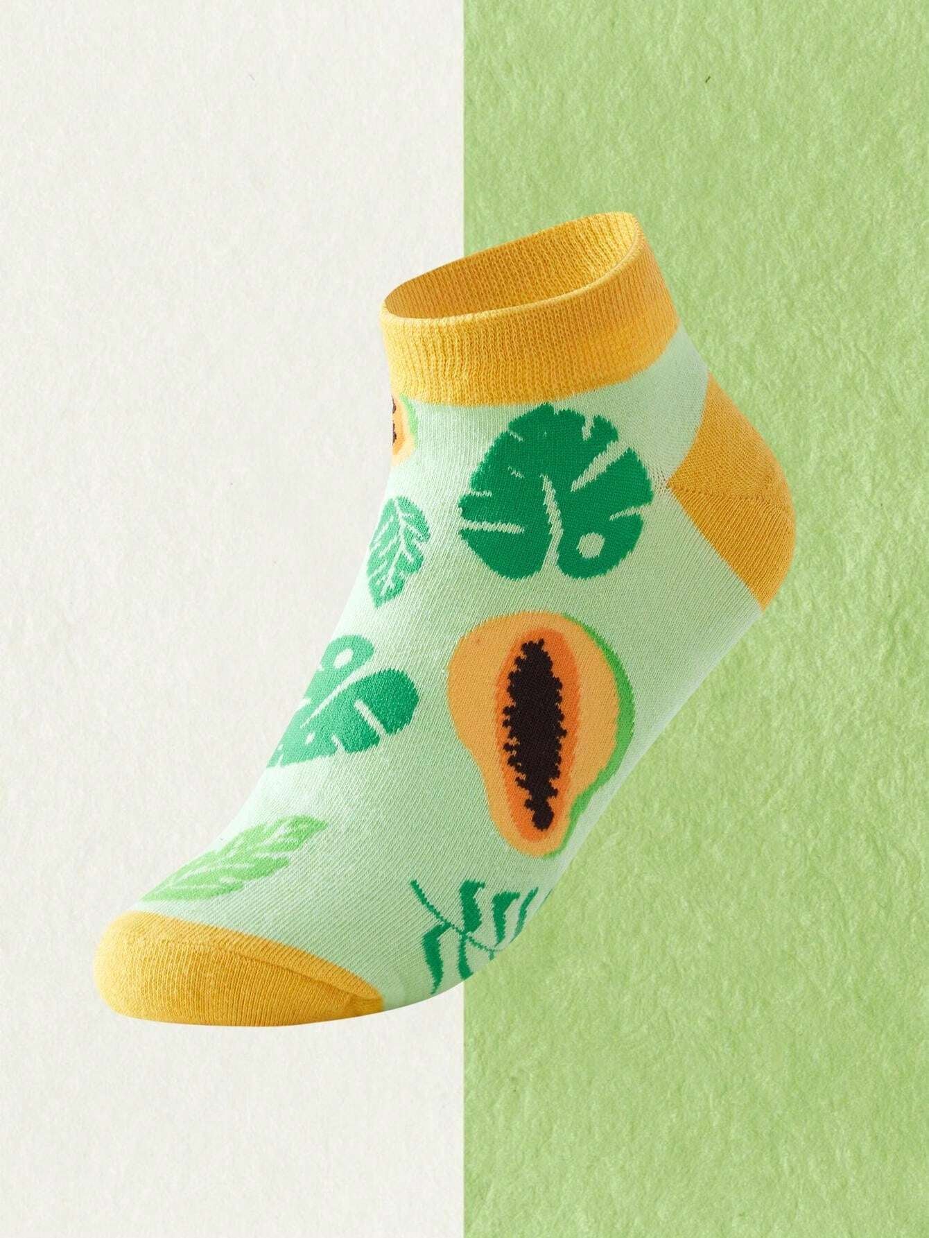 Sock with tropical leaf and papaya design on a light green background