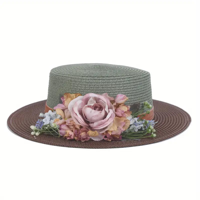 Vintage green and brown floral boater hat made of papyrus with soft mauve, blush, and cream flowers, styled on wicker basket with rustic decor.