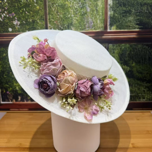 Vintage white boater hat decorated with pastel artificial roses and green leaves, handmade sun hat for garden parties and weddings