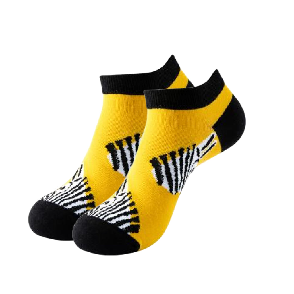 Two yellow socks with black and white zebra pattern on a white background