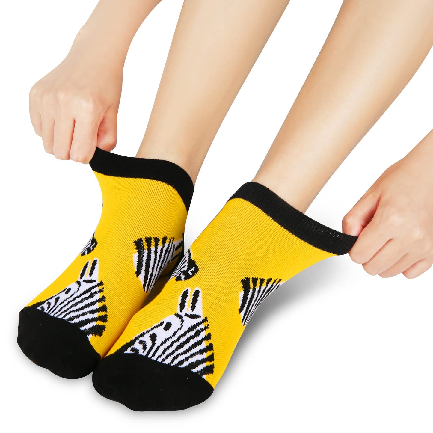 Yellow socks with zebra pattern worn by a person on a white background