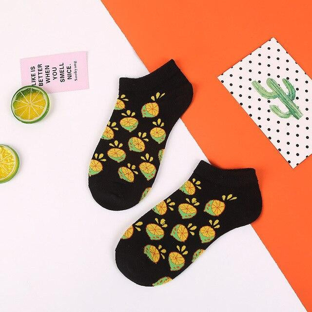 Quirky black socks with lemon pattern on a colorful background