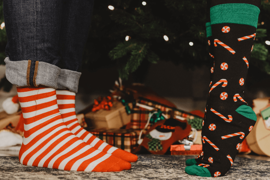 Banner image for Lazzy Socks featuring a group of people wearing colorful and playful socks. The background is a mix of bright colors and fun patterns. The image showcases the brand's commitment to funky and unique fashion.