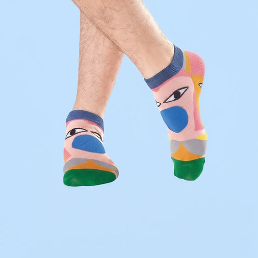 Colorful socks with abstract designs on a light blue background