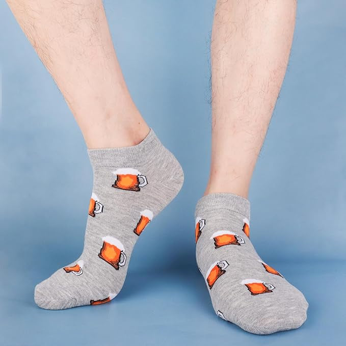 Gray socks with beer mug pattern worn by a person on a blue background