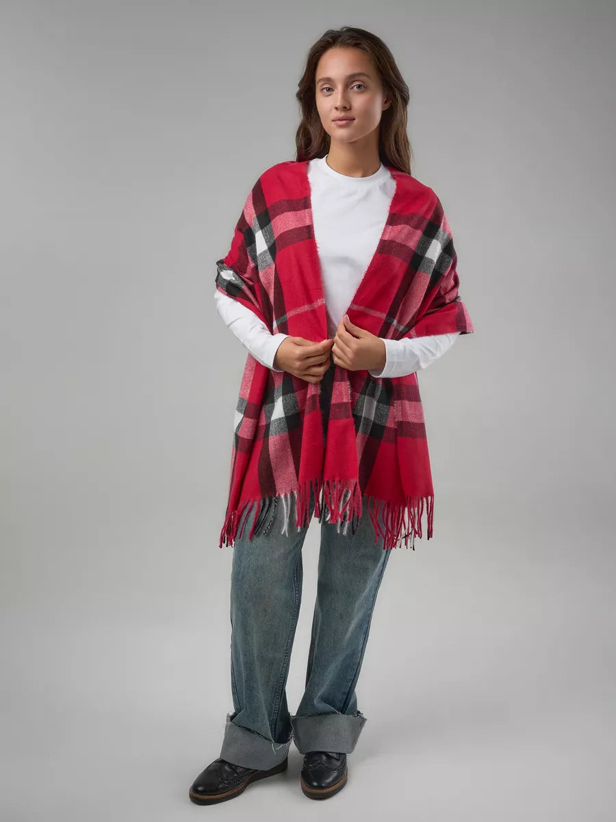 Person wearing a red plaid scarf on a gray background