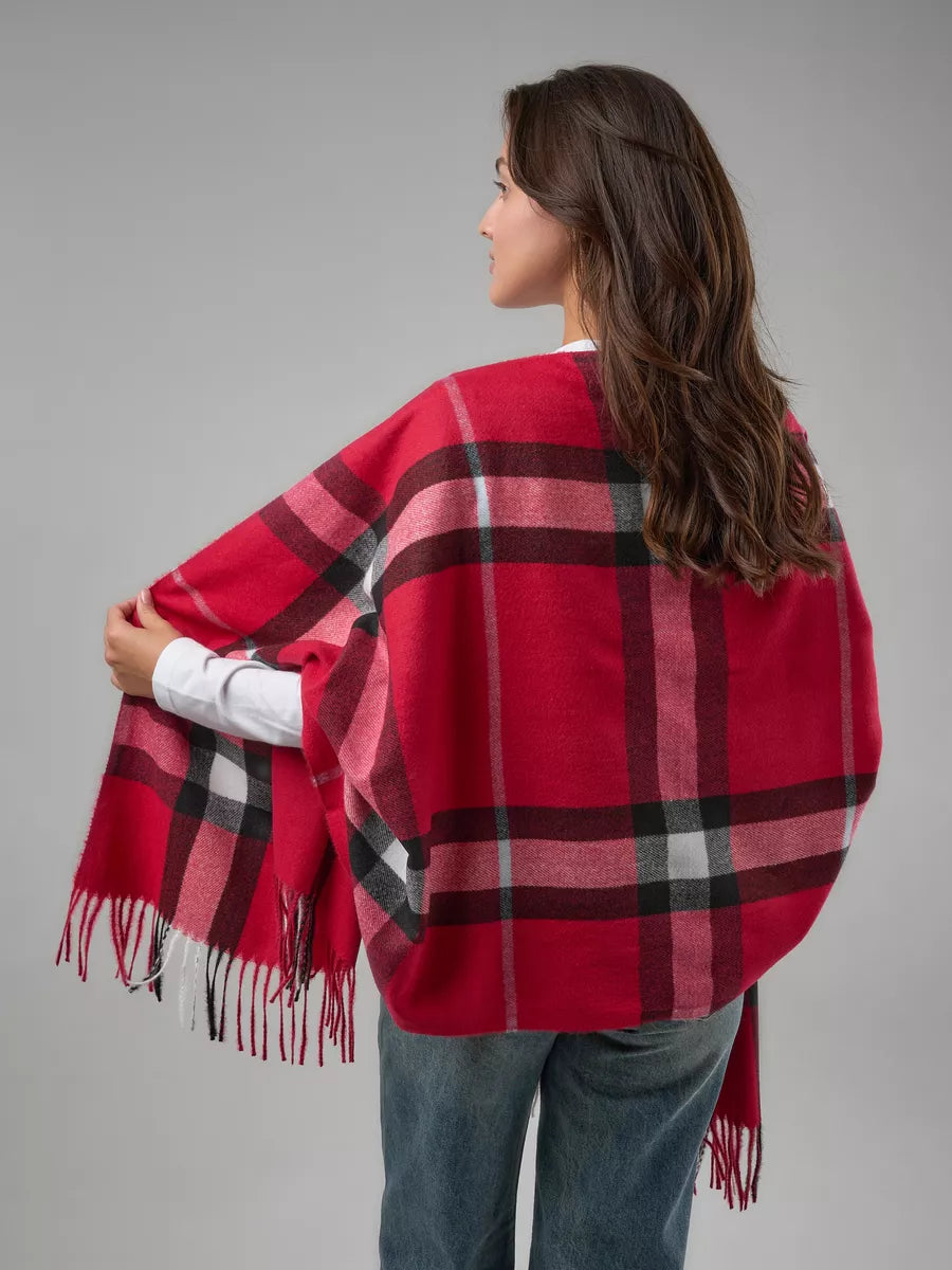Woman wearing a red plaid scarf against a gray background