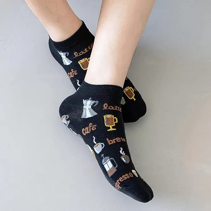 Black socks with coffee-themed designs on a light gray background