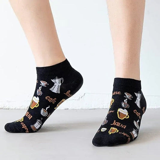 Black socks with coffee-themed designs worn by a person on a light background