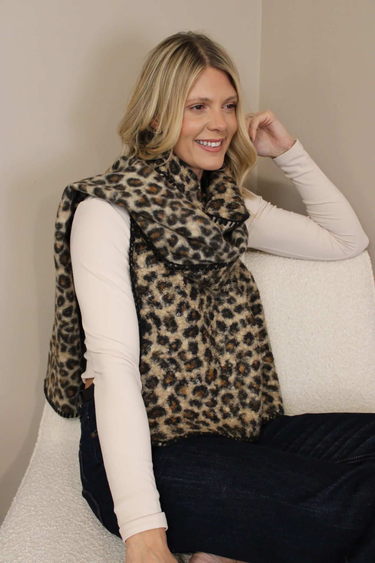 Model wearing a warm brown leopard print scarf wrapped over a long sleeve top