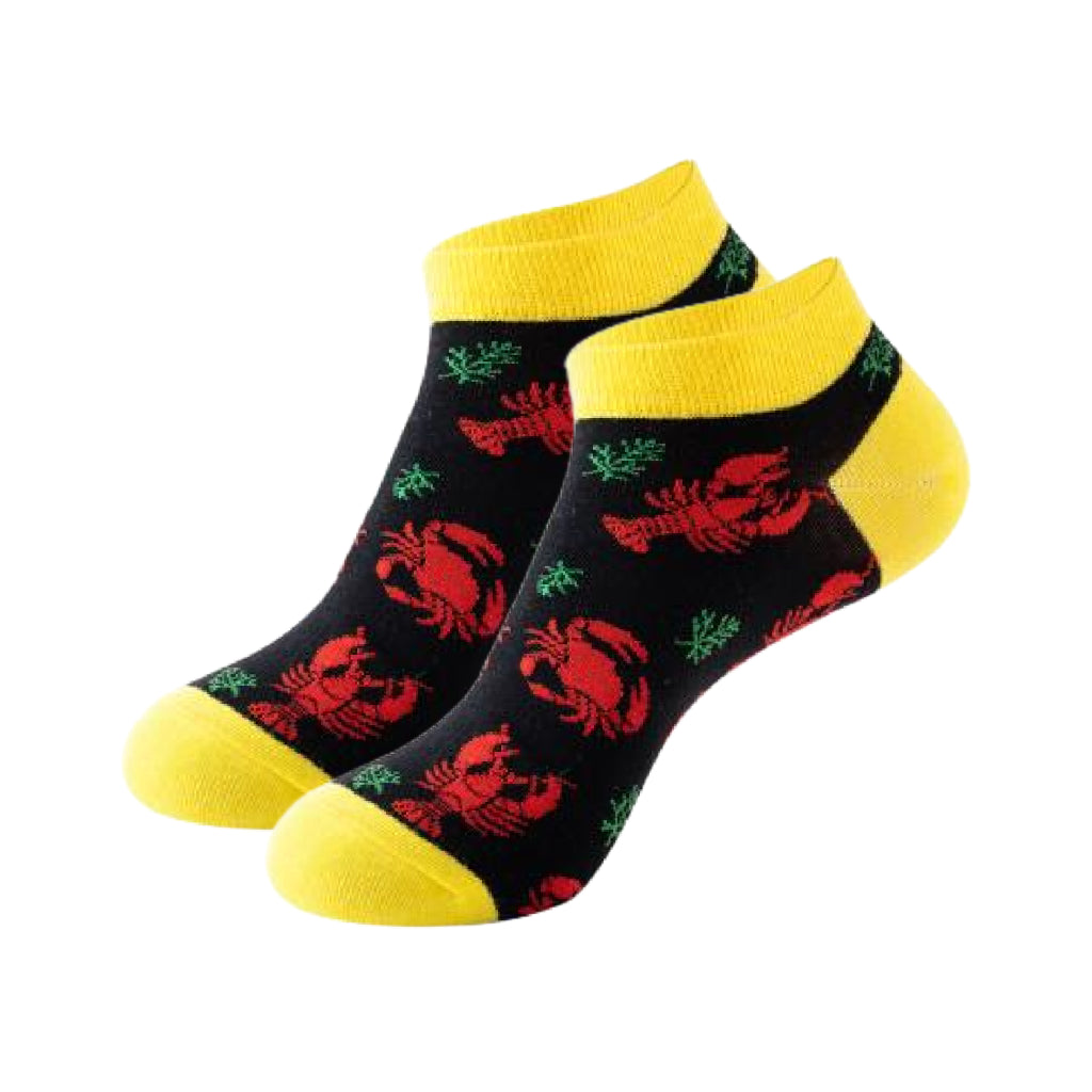 Black socks with red lobster design and yellow accents on a white background