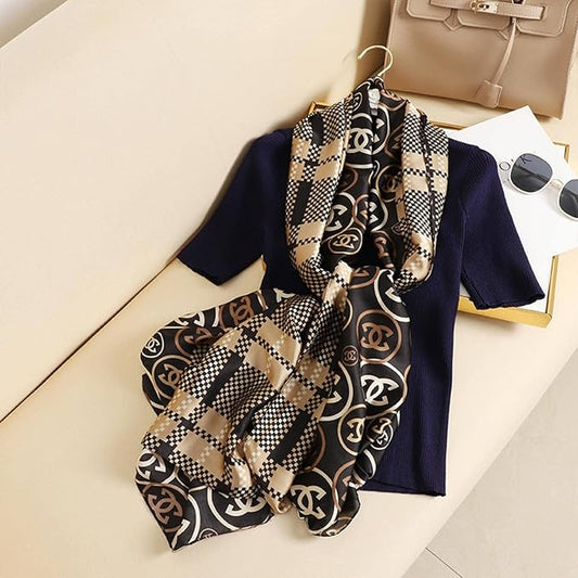 Discover ultimate versatility with this luxurious silk-feel satin scarf. Featuring a unique dual pattern of a chic beige & black check and a classic monogram, this 90 x 180 cm scarf offers multiple styling options.