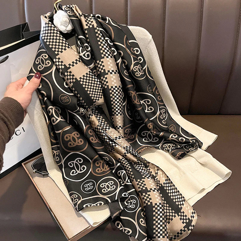 Discover ultimate versatility with this luxurious silk-feel satin scarf. Featuring a unique dual pattern of a chic beige & black check and a classic monogram, this 90 x 180 cm scarf offers multiple styling options.