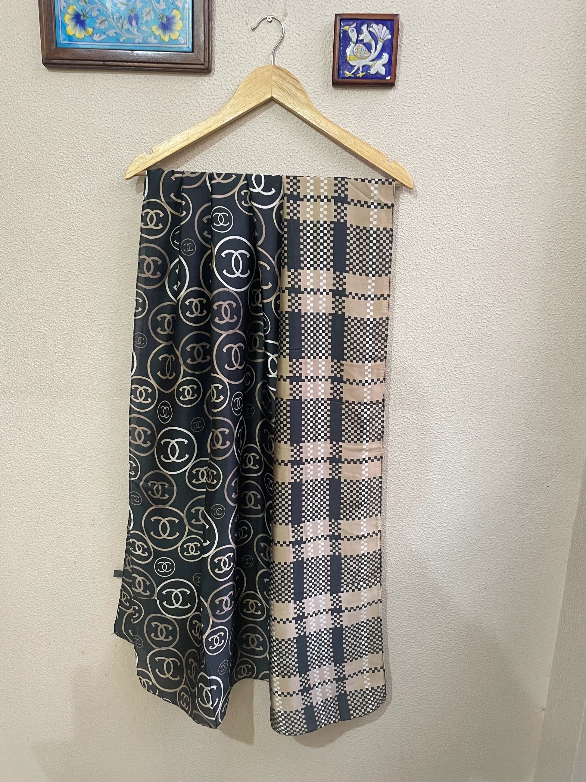 Discover ultimate versatility with this luxurious silk-feel satin scarf. Featuring a unique dual pattern of a chic beige & black check and a classic monogram, this 90 x 180 cm scarf offers multiple styling options.