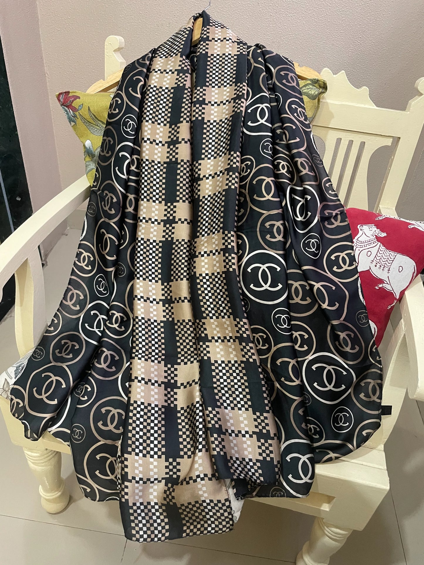 Discover ultimate versatility with this luxurious silk-feel satin scarf. Featuring a unique dual pattern of a chic beige & black check and a classic monogram, this 90 x 180 cm scarf offers multiple styling options.