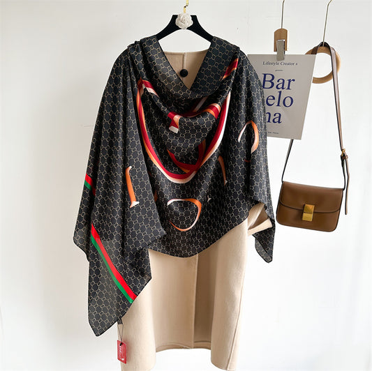 Discover sophistication with this luxurious silk-feel satin scarf. Featuring a black and gold monogram, a bold abstract graphic, and a signature red and green stripe, this 90 x 180 cm scarf is a true statement piece.