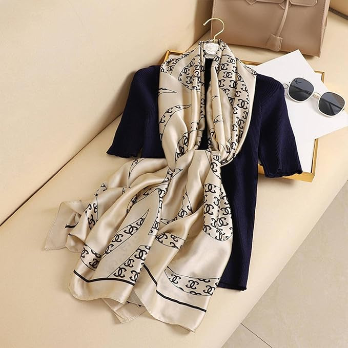 Experience timeless elegance with this luxurious silk-feel satin scarf. Features a chic cream and black monogram arranged in a sophisticated chain pattern. Measures 90 x 180 cm. The perfect accessory for any occasion.