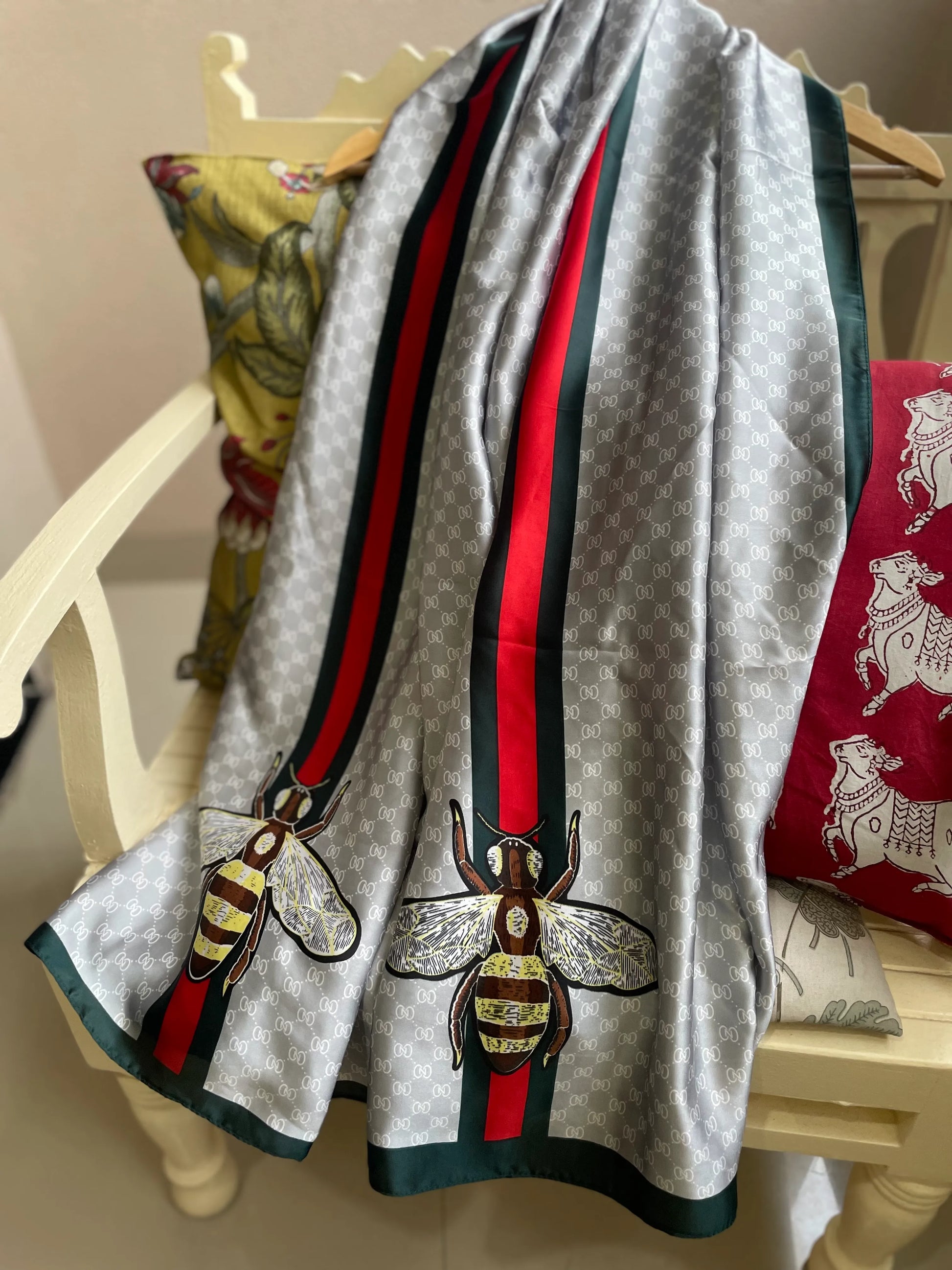 Elevate your style with this luxurious silk-feel satin scarf in light grey monogram with a bold red and green stripe and charming bee motif. Measuring 90 x 180 cm, it’s perfect for evening wear, travel, or as a sophisticated gift.
