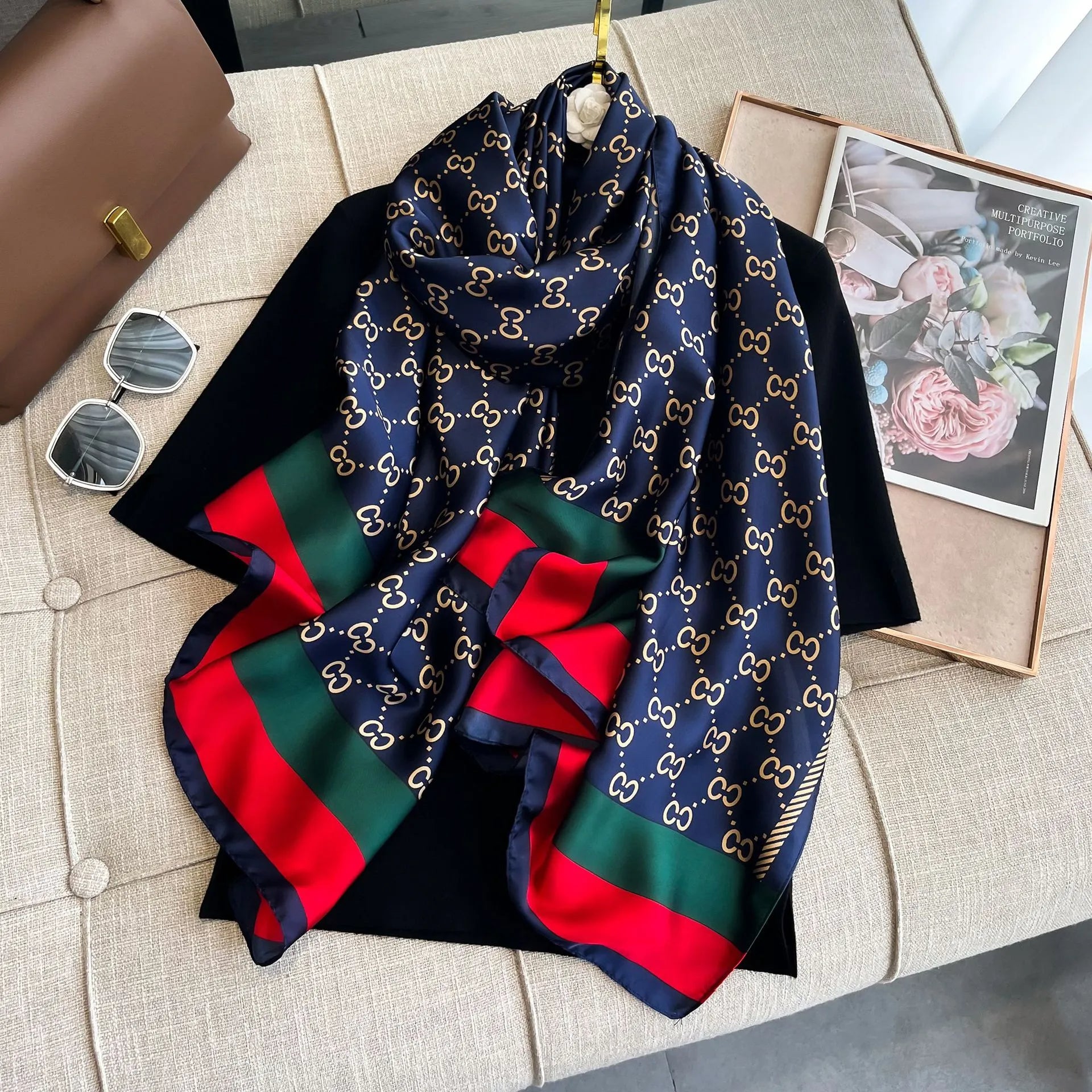 Elevate your style with this luxurious silk-feel satin scarf. Features a deep navy and gold monogram design with iconic red and green stripes. Size 90 x 180 cm.

