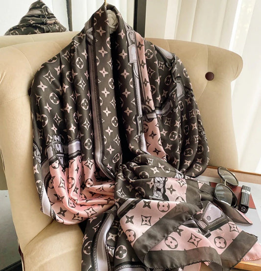 Elevate your style with this luxurious silk-feel satin scarf in delicate pink, elegant grey, and white with an iconic monogram pattern. Measuring 90 x 180 cm, it’s perfect for evening wear, travel, or as a sophisticated gift.
