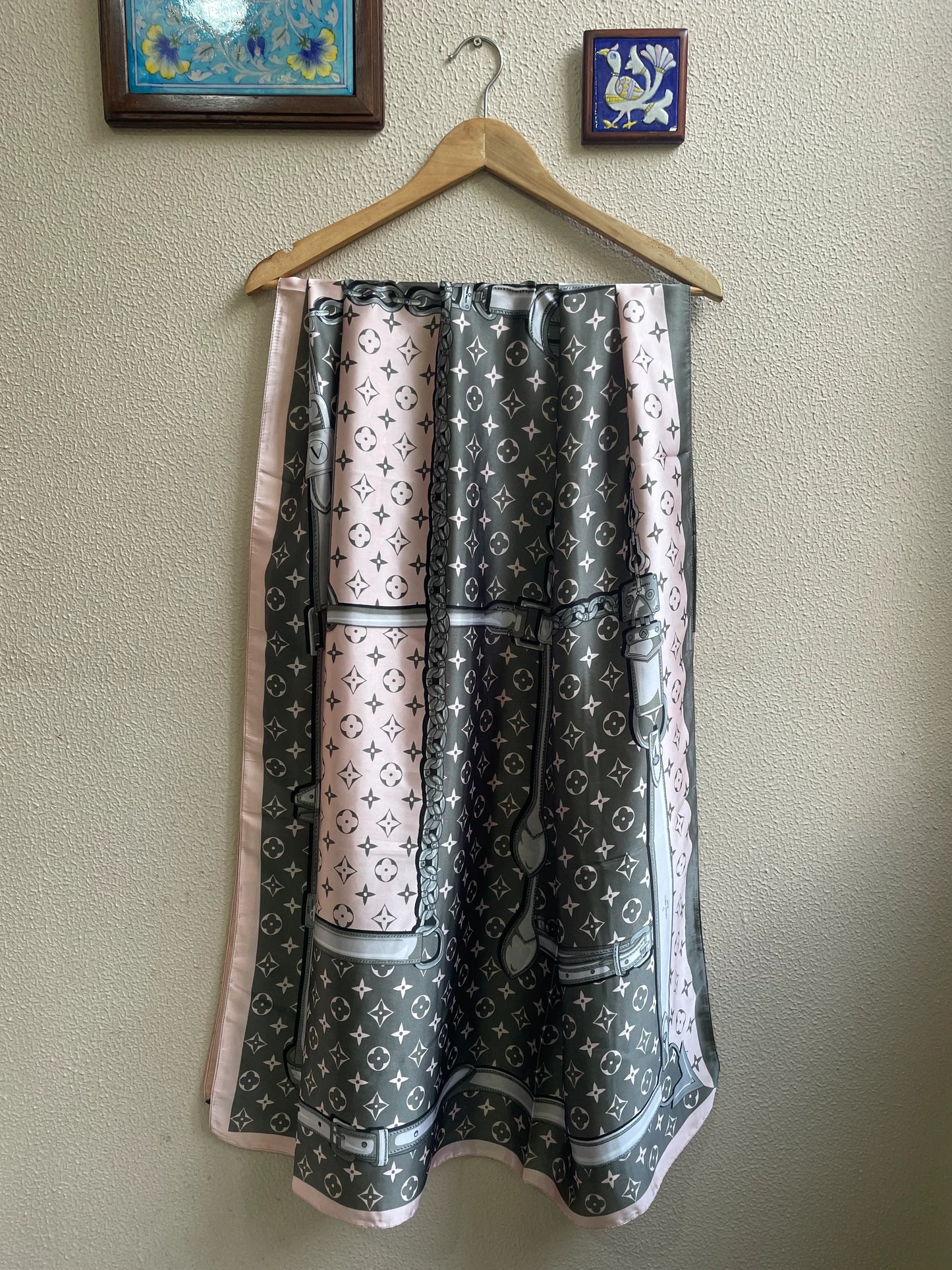 Luxury pink, grey, and white silk-feel satin scarf with an iconic monogram pattern – hanging