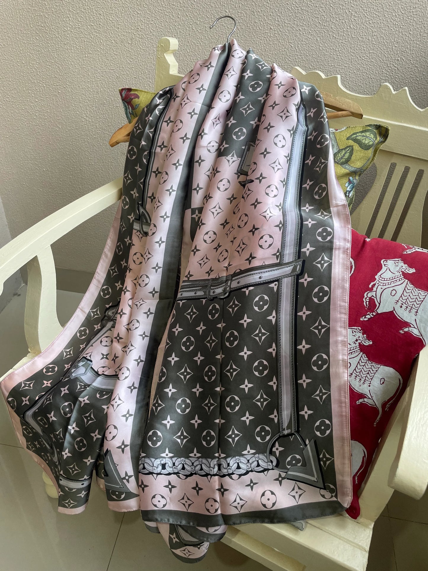 Elegant pink, grey, and white designer satin scarf draped over a chair – monogram print