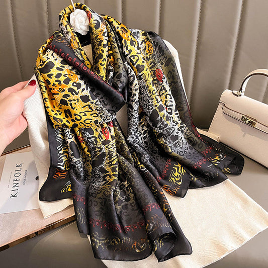 Make a bold statement with this luxurious silk-feel satin scarf featuring a vibrant yellow and black abstract animal print with red accents. Measures 90 x 180 cm. Perfect for elevating your style.
