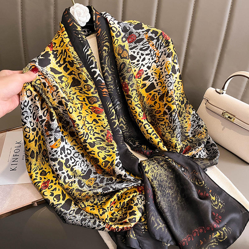 Make a bold statement with this luxurious silk-feel satin scarf featuring a vibrant yellow and black abstract animal print with red accents. Measures 90 x 180 cm. Perfect for elevating your style.
