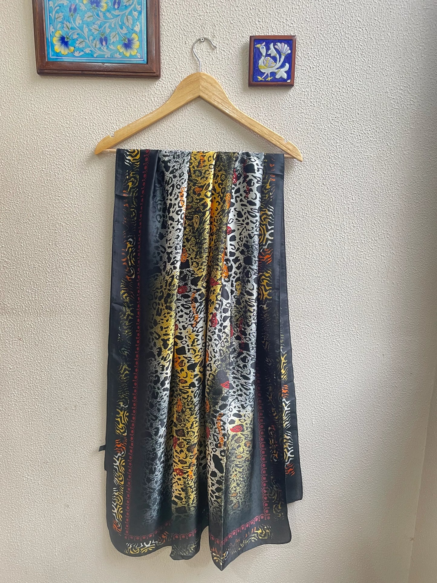 Make a bold statement with this luxurious silk-feel satin scarf featuring a vibrant yellow and black abstract animal print with red accents. Measures 90 x 180 cm. Perfect for elevating your style.
