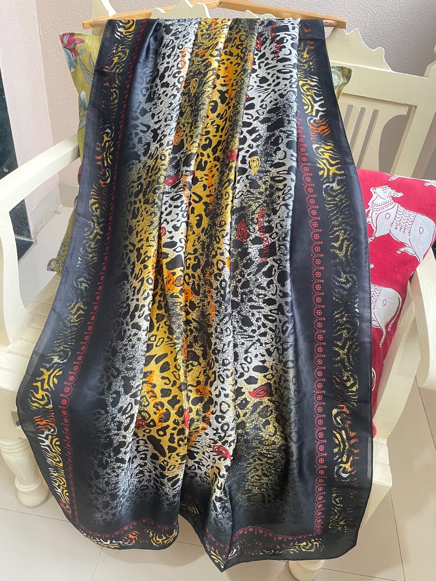 Make a bold statement with this luxurious silk-feel satin scarf featuring a vibrant yellow and black abstract animal print with red accents. Measures 90 x 180 cm. Perfect for elevating your style.

