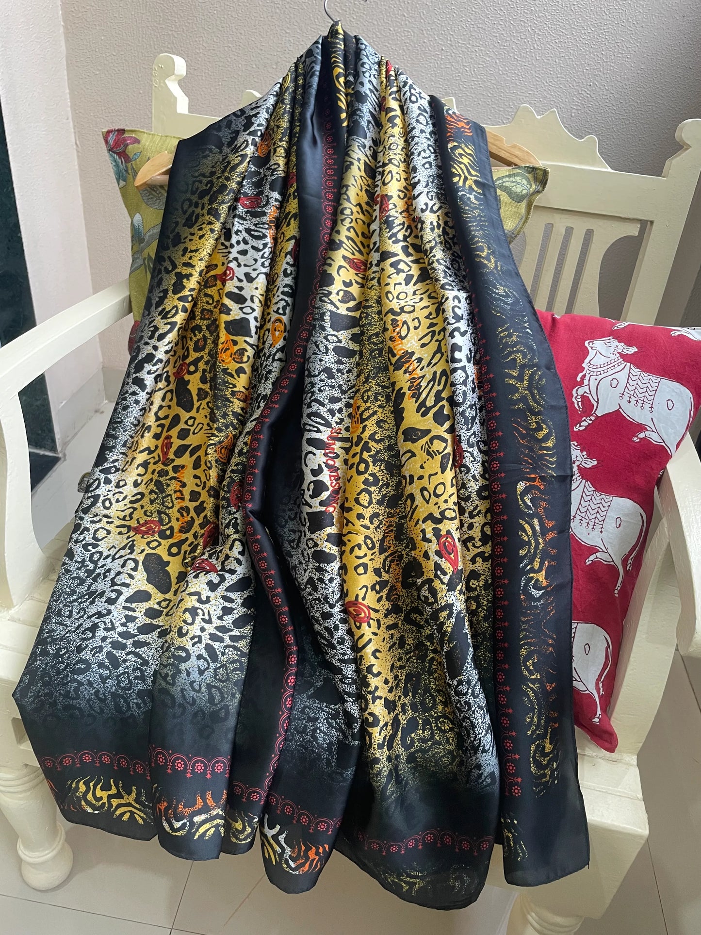 Scarf with animal print patterns draped over a chair