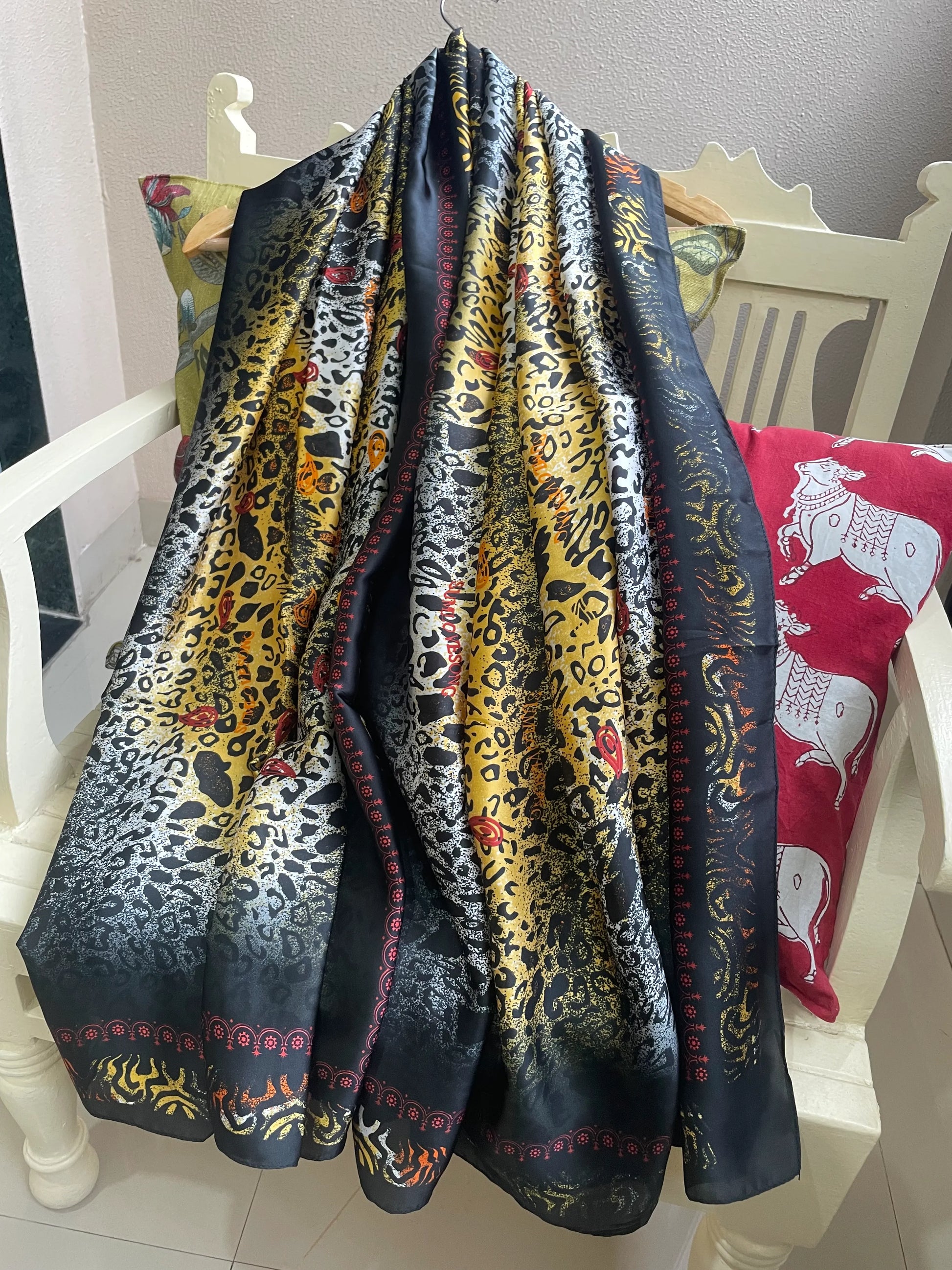 Scarf with animal print patterns draped over a chair