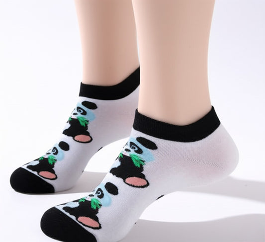 White socks with panda design worn by a person on a white background