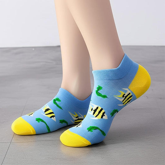 Blue socks with fish pattern worn by a person on a gray floor.