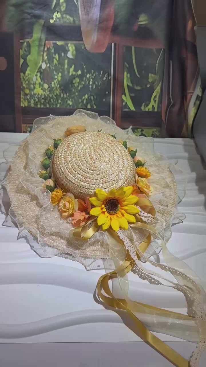 Embrace countryside charm with our Marisol sunflower straw hat. This vintage-inspired boater features a ruffled lace brim, pearl accents, and flowing yellow ribbons. Perfect for summer events.